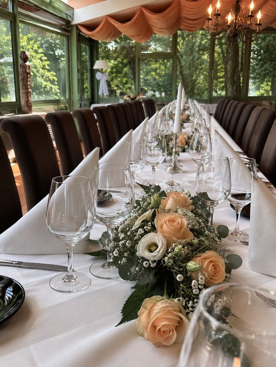 Festliche Tafel mit Rosen und Kerzen im Wintergarten